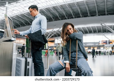 Woman is tired. Young couple is in the airport together. - Shutterstock ID 2203729173