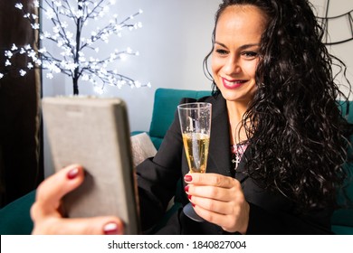 Woman Toasting With Champagne Towards Mobile At Home