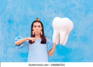 Woman In Tooth Fairy Costume Holding Big Molar. Funny Princess Holding An Oversized Fallen Baby Tooth 
