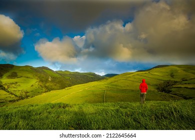 Woman in the top of a hill comtemplating the beauty of nature, Azores Island.