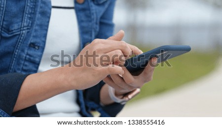 Woman touch on smart phone in city