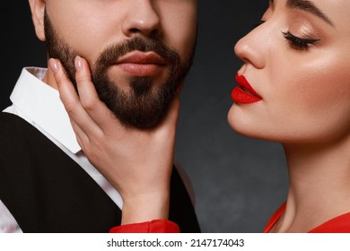 Woman Touching Bearded Man's Face On Dark Background, Closeup