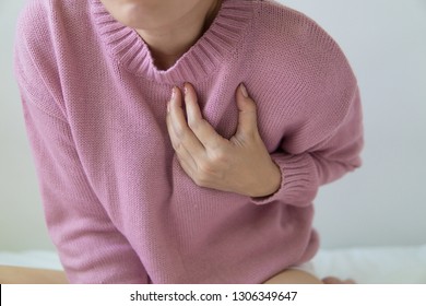 Woman Touching Breast And Having Chest Pain.