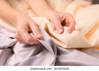 Woman touching different soft fabrics, closeup view