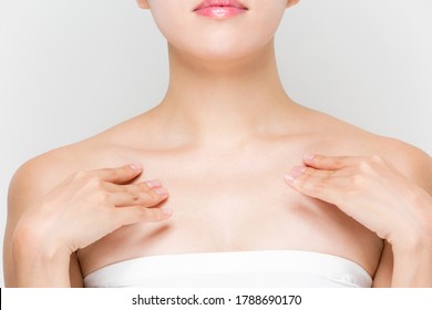 A Woman Is Touching Her Clavicle.