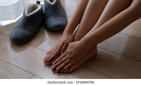 A Woman Touching Her Feet In The Cold Winter