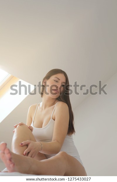 Woman touching her\
legs.