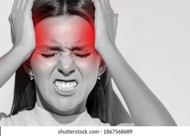 Woman touching her temples, having strong tension headache. Cluster headache, migraine. Hands on head - Shutterstock ID 1867568689