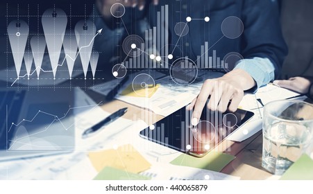 Woman Touching Screen Electronic Tablet Hand.Project Managers Researching Process.Business Team Working New Startup modern Office.Digital Connections world wide interfaces.Analyze market stock.Blurred
