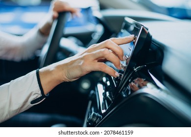 Woman Touching Screen In Her Car