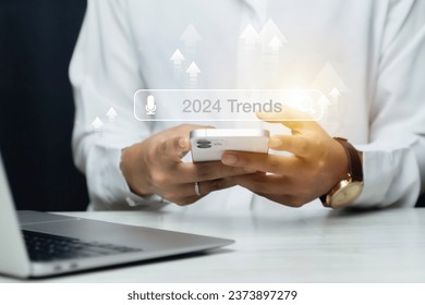 Woman touching to search engine bar with 2024 trends wording for marketing monitor and business planing in new year concept. Finding information and new ideas for doing business in 2024.
