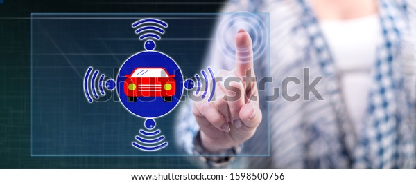 Woman touching a smart car concept on a touch\
screen with her finger