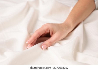 Woman touching smooth silky fabric, closeup view