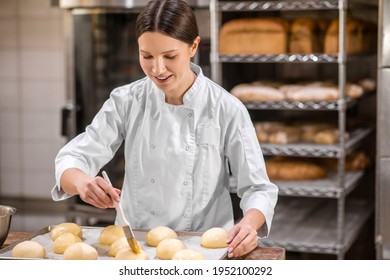 Woman touching with special brush to rolls - Powered by Shutterstock