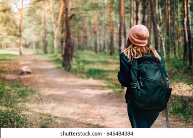 Woman Tourism. Back Of  Traveler In The Forest Looks For The Road. Beautiful Young Woman Is Traveling And Camping In The Forest