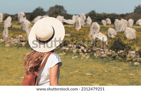 Woman tourist at Carnac- Alignment of menhirs