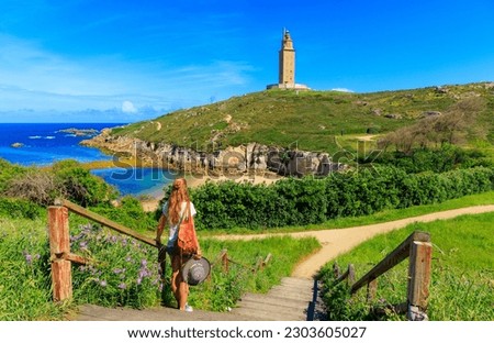 Woman tourist enjoying beautiful view of Hercules tower, A Coruna, Galicia in Spain