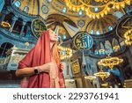 Woman tourist enjoying Hagia Sofia, Ayasofya interior in Istanbul, Turkey, Byzantine architecture, city landmark and architectural world wonder. Turkiye