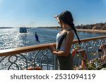 Woman tourist enjoying a luxurious cruise on the Nile River and feeling like royalty. Exploring ancient tombs, savoring delicious dishes and creating indelible memories on this unforgettable journey.