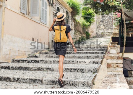 Woman tourist enjoying vacation in old town. Girl traveler walking in an italian city. Travel alone, active lifestyle, enjoy life, summer holidays, vacations, people concept