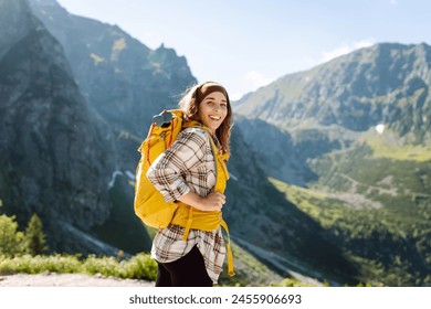 Woman tourist explores nature in the mountain area. Nature, active life, travel. - Powered by Shutterstock