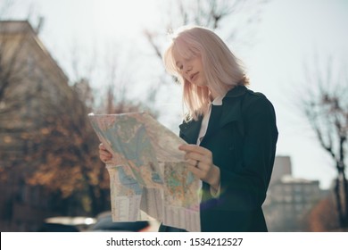 Woman Tourist Exploring European City While Holding Map