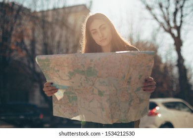 Woman Tourist Exploring European City While Holding Map