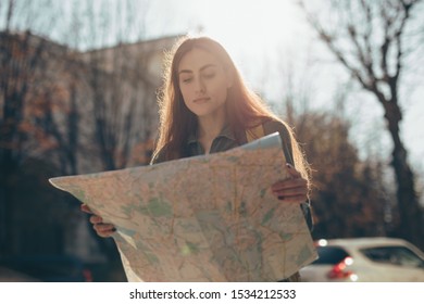 Woman Tourist Exploring European City While Holding Map