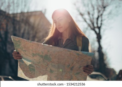 Woman Tourist Exploring European City While Holding Map