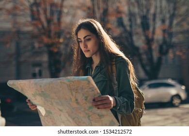 Woman Tourist Exploring European City While Holding Map