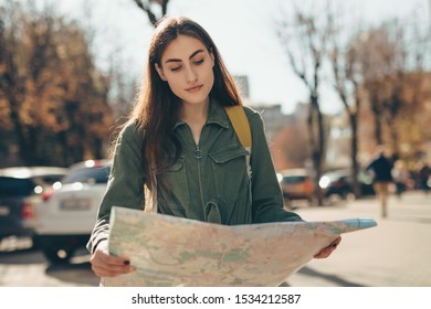 Woman Tourist Exploring European City While Holding Map