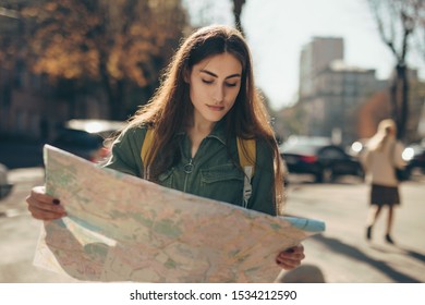 Woman Tourist Exploring European City While Holding Map