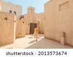 Woman tourist getting lost the old narrow streets of Bur Dubai and Creek. Travel and sightseeing journey concept