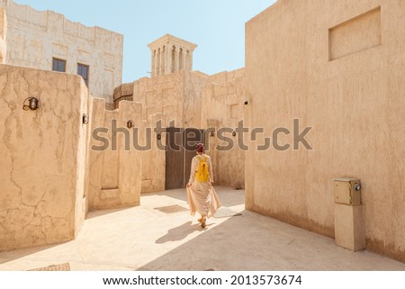 Woman tourist getting lost the old narrow streets of Bur Dubai and Creek. Travel and sightseeing journey concept