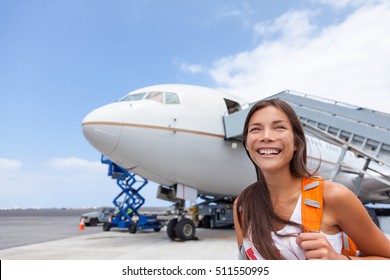 Woman tourist getting out of airplane at airport. Asian girl passenger walking out of stairs after plane landing arrival at airport at summer destination travel. Tourism concept.