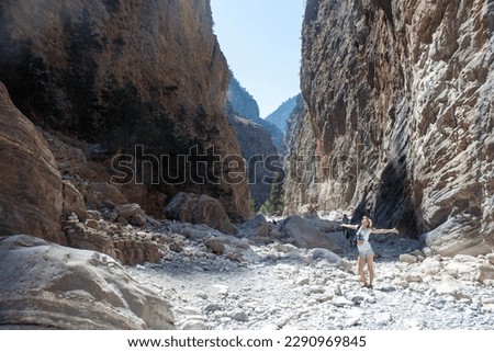 woman tourist on the background of a rocky gorge. The concept of an active lifestyle, sports and feminism.