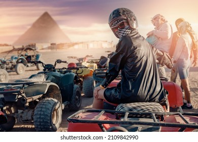 Woman tourist on quad bike ATV safari in desert background Pyramids Sphinx Cairo, Egypt.