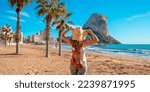 Woman tourist on the tropical beach,  Calpe,  Alicante province in Spain, costa blanca