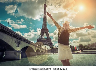 Woman Tourist Selfie Near The Eiffel Tower In Paris Under Sunlight And Blue Sky. Famous Popular Touristic Place In The World.