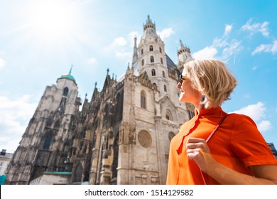 Woman tourist stands near St. Stephen's Cathedral on Stefansplatz in Vienna and enjoys the views of the main attractions of the city, Vienna, Austria