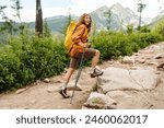 Woman tourist traveler walking along hiking trails in the mountains among forests and cliffs. Travel Slovakia, Europe. Concept of trekking, active lifestyle. Adventures.