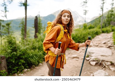 Woman tourist traveler walking on the top of mountain in summer sunny day under sun light. Beautiful mountains landscape view. Concept of trekking, active lifestyle. Adventures. - Powered by Shutterstock