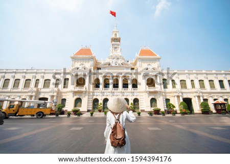 Woman tourist is traveling and sightseeing at Hochiminh people's committee hall landmark of Saigon, Vietnam.