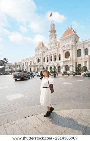 Woman tourist is traveling and sightseeing at Hochiminh people's committee hall landmark of Saigon, Vietnam.