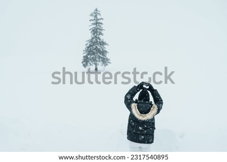 Woman tourist Visiting in Biei, Traveler in Sweater sightseeing Christmas tree with Snow in winter season. landmark and popular for attractions in Hokkaido, Japan. Travel and Vacation concept