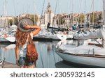 Woman tourist visiting old port and city of La Rochelle. Charente-Maritime in France