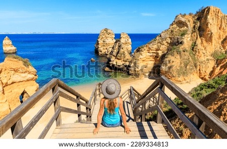 Woman tourist visiting Portugal- Beach praia do camilo near Lagos,  in Algarve- vacation, travel, summer holiday concept