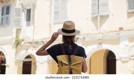 Woman tourist walking in old town, travel concept. Young woman traveler enjoying vacations. Travel alone, active lifestyle, enjoy life, summer fun, holidays, vacations, people concept