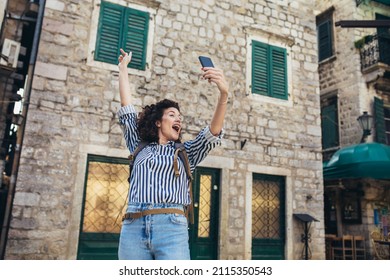 Woman Tourist Walking On The Street And Make Selfie Photo.