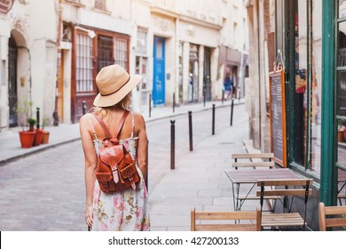 woman tourist walking on the street, summer fashion style, travel to Europe